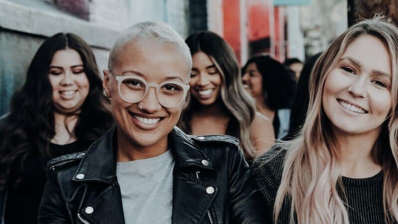 man in black leather jacket beside woman in black and white stripe shirt