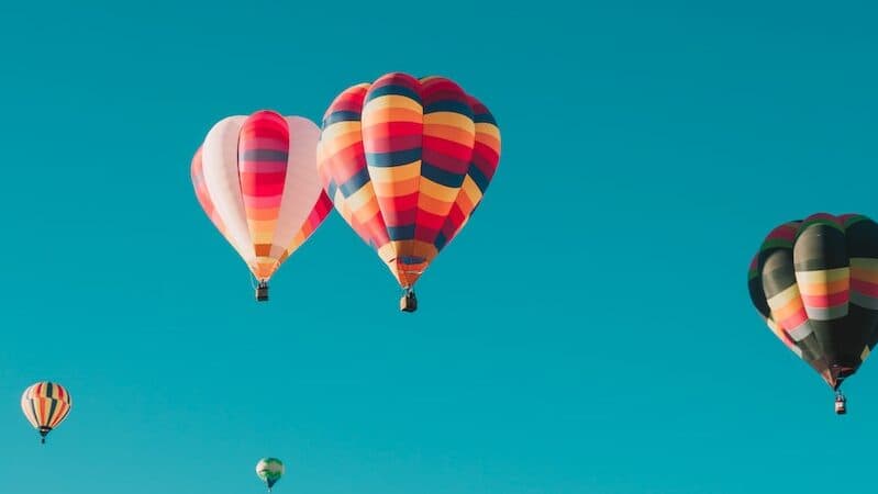 assorted hot air balloons flying at high altitude during daytime